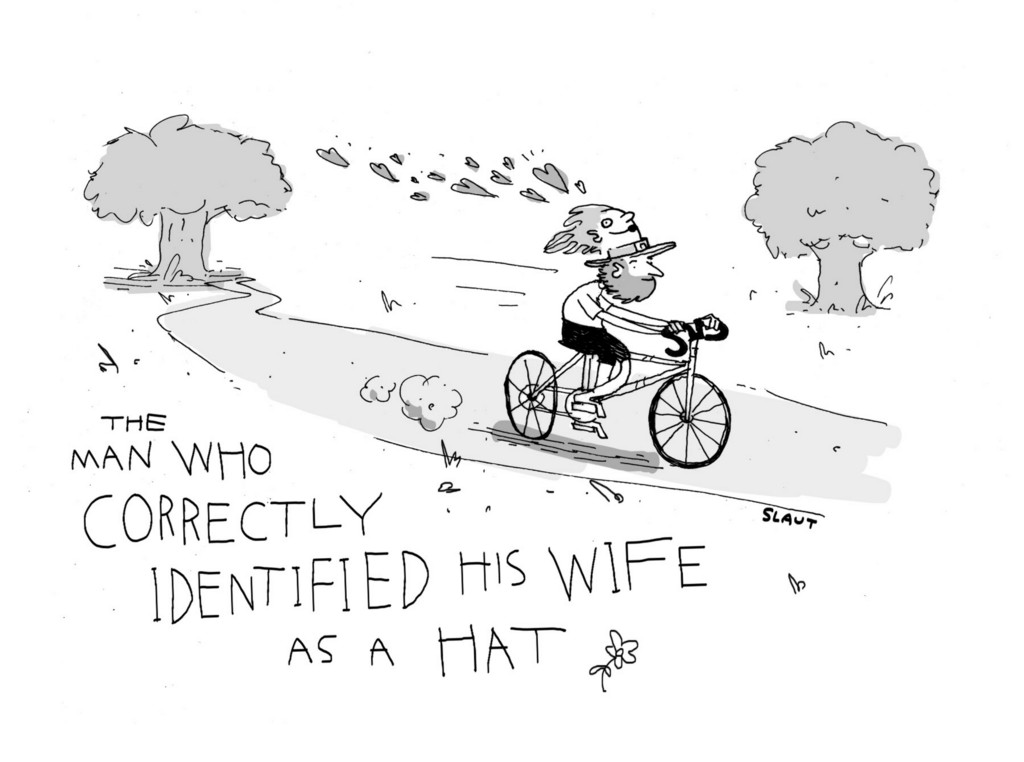 (Man, riding a bike with a hat that looks like a woman's head.) The man who correctly identified his wife as a hat. 