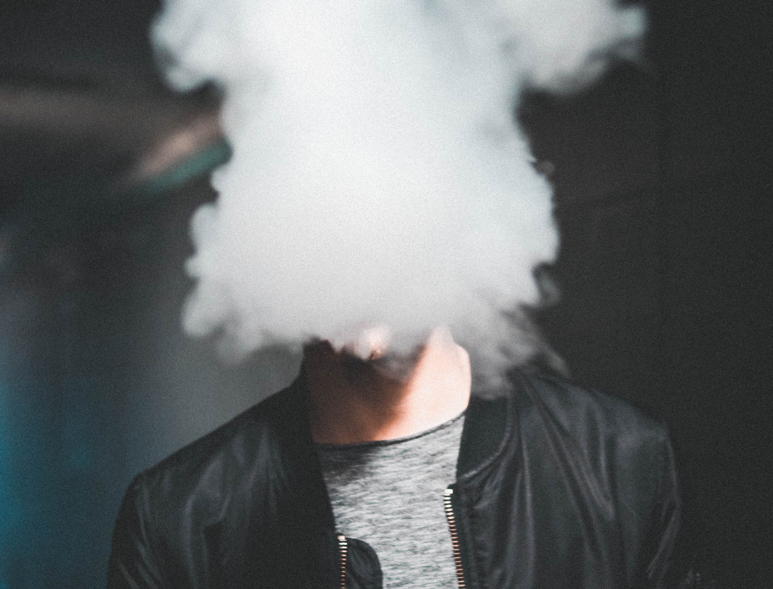 Man whose face is obscured by smoke