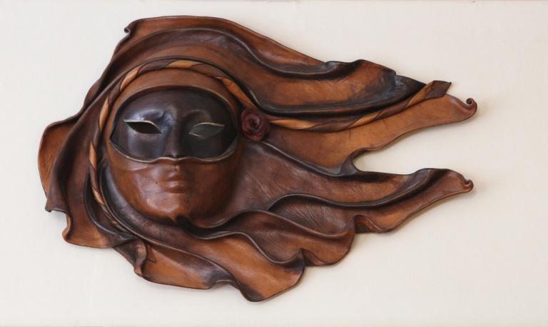 Leather mask that is also wearing a smaller mask