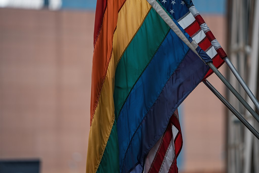 Pride flag and American flags hanging together