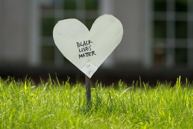 "Black Lives Matter" written on white paper heart