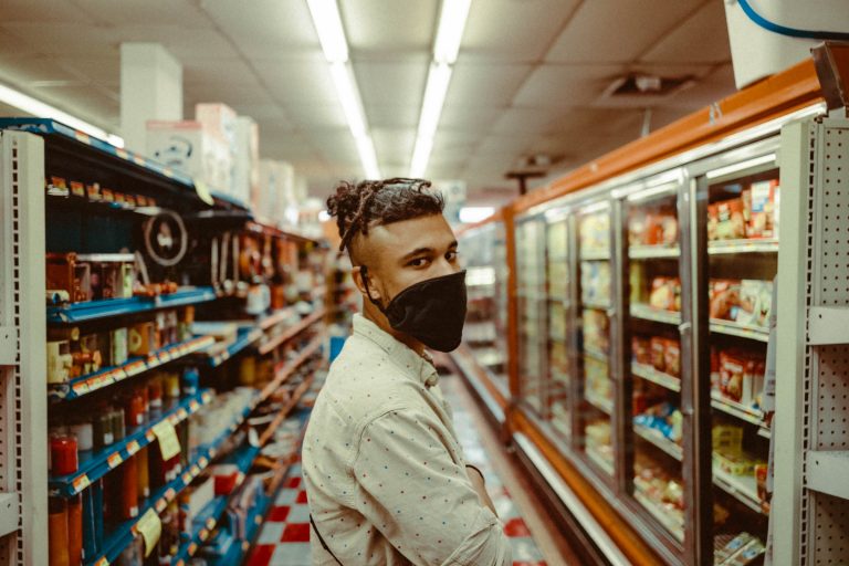 Person with mask in grocery aisle