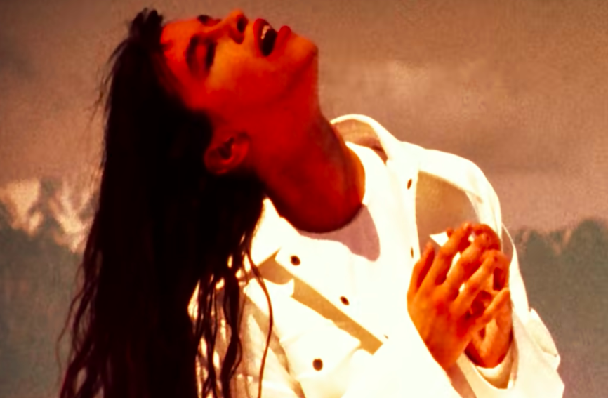 Alanis looking prayerful in the "You Oughta Know" video