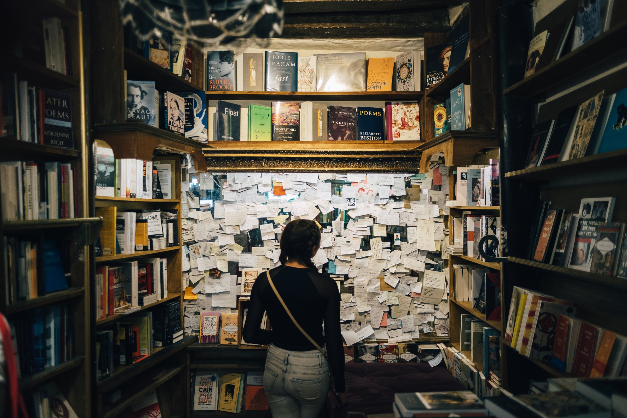 Woman looking at bulletin board in bookstore