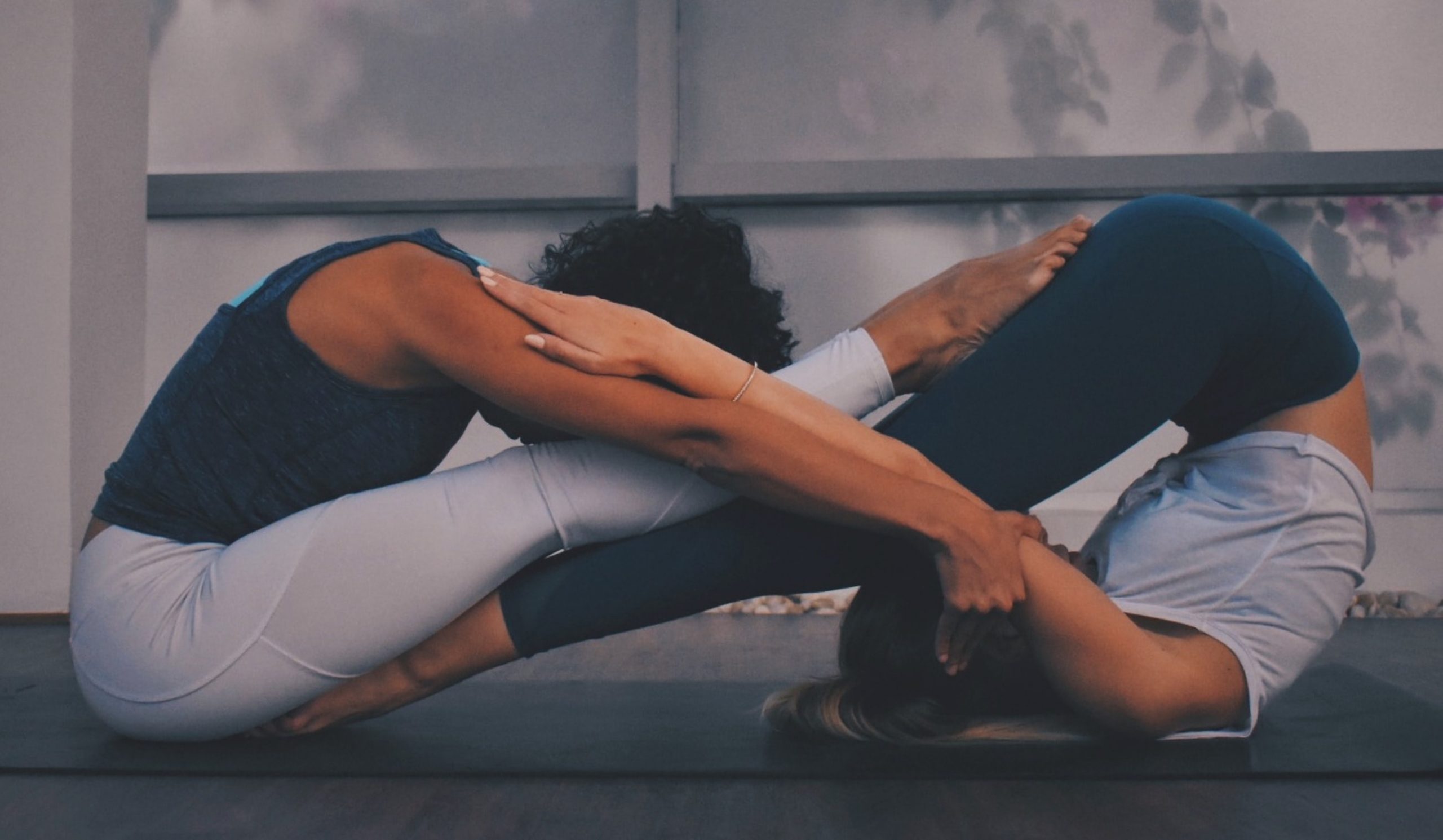 two people doing yoga