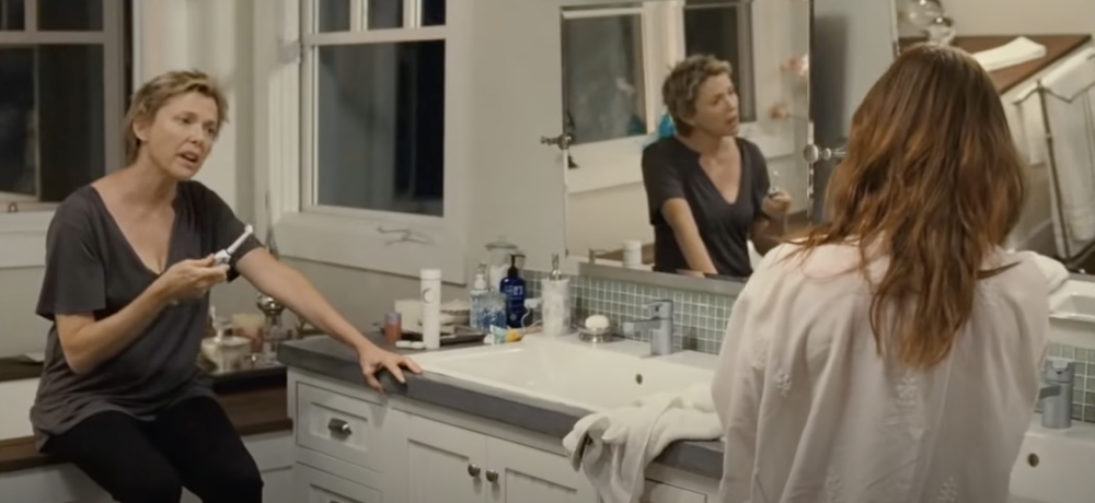 Screenshot from "The Kids Are Alight," showing leads Nicole Allgood (played by Annette Bening) and Jules Allgood (played by Julianne Moore) talking in a bathroom