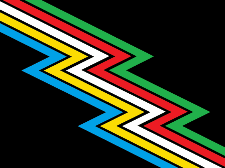 Disability Pride Flag, designed by Ann Magill. A charcoal grey/almost-black flag crossed diagonally from top left to bottom right by a “lightning bolt” band divided into parallel stripes of five colors: light blue, yellow, white, red, and green.