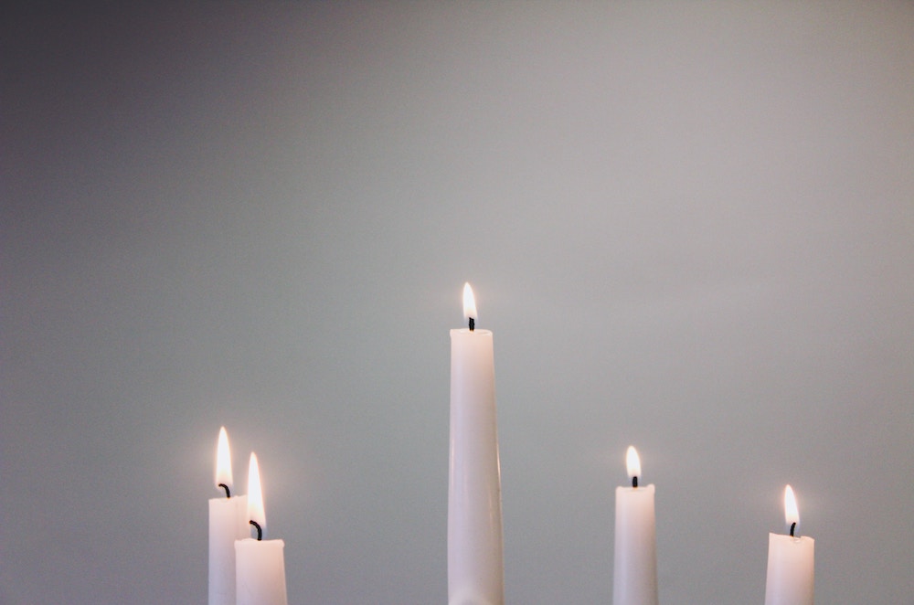 Candles lit on gray background