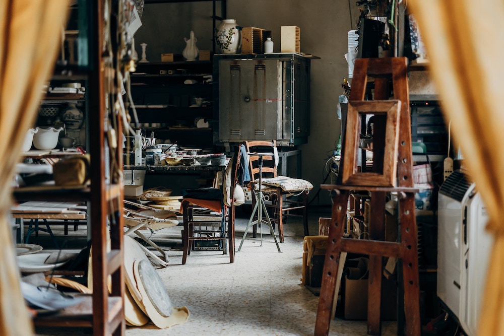 Artist studio with wood frames and paint scattered