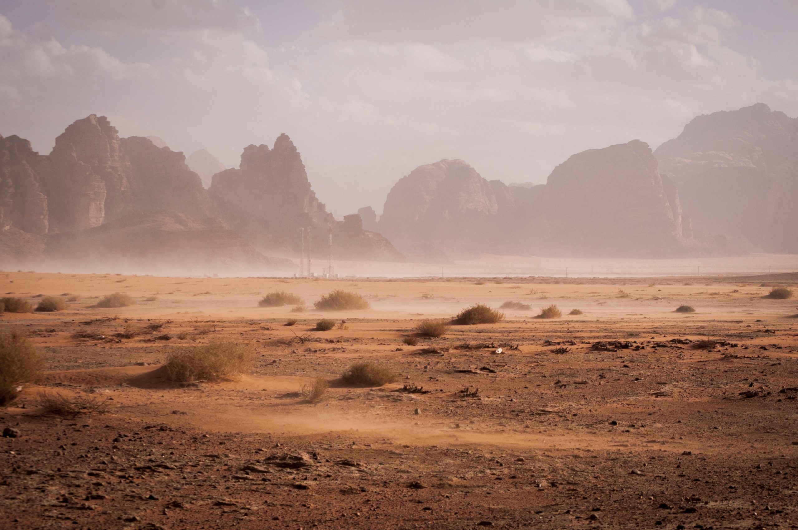 A desert scene with mountains in the background