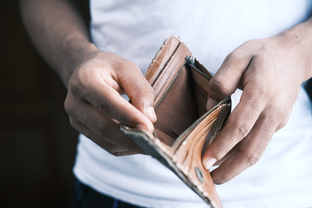 A man opens an empty wallet