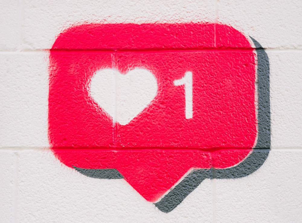 Red wall art of a 'like' notification