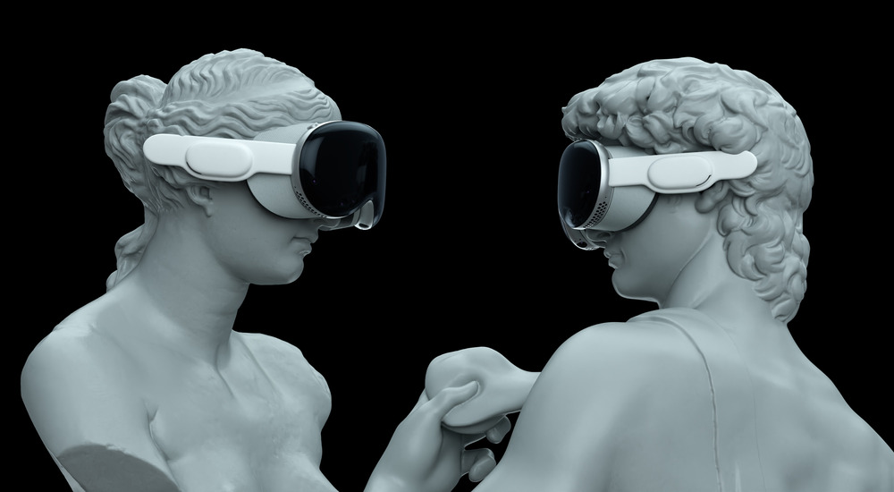 Two Greek statues, one woman and one man, face each other while wearing VR goggles