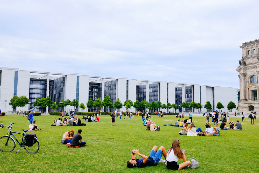 Students lounge on the grass at a college campus