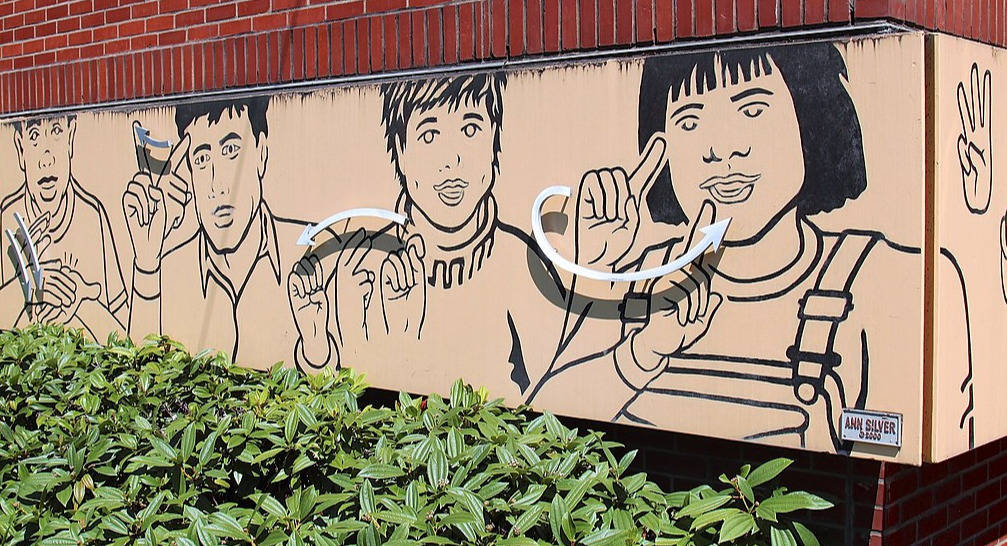 A mural of people using sign language at the Washington School for the Deaf in Vancouver